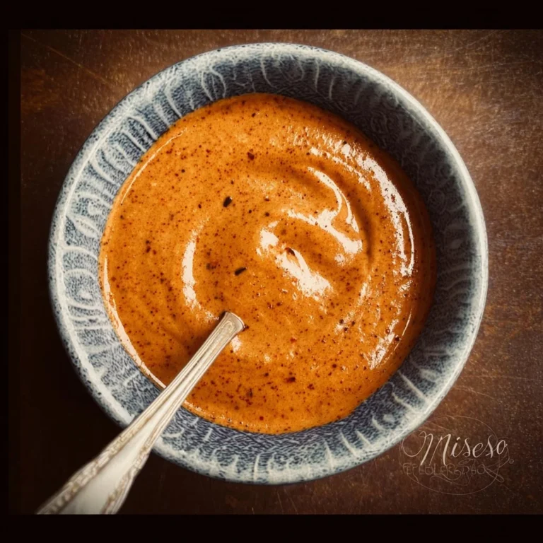 Homemade chipotle sauce drizzled over tacos and garnished with fresh herbs