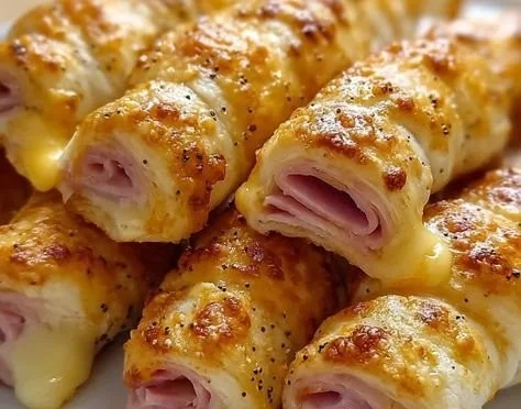 Homemade ham and cheese sticks on a plate, perfect for appetizers.