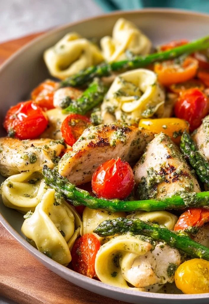Delicious one-pan pesto chicken with tortellini and colorful veggies