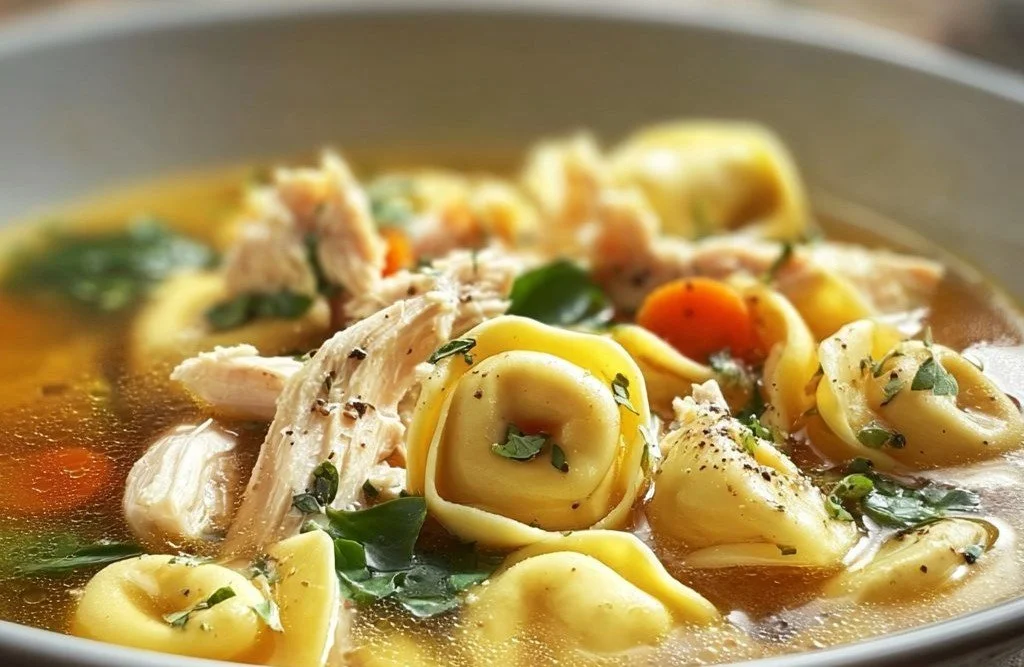 Delicious Chicken Tortellini Soup in a bowl garnished with herbs